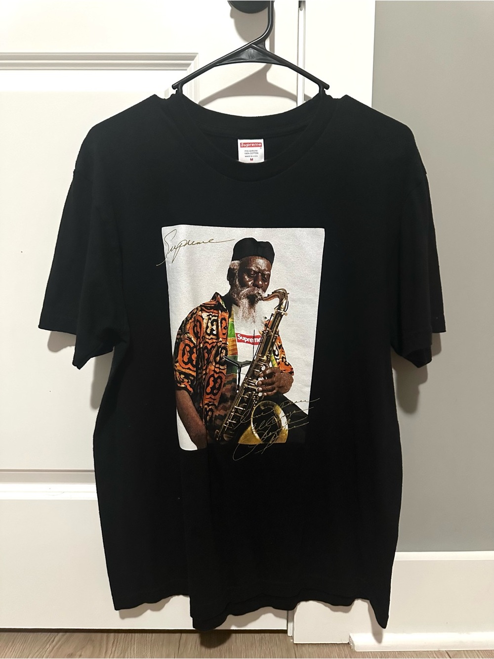 Supreme Black Tee with Colorful Saxophonist Graphic